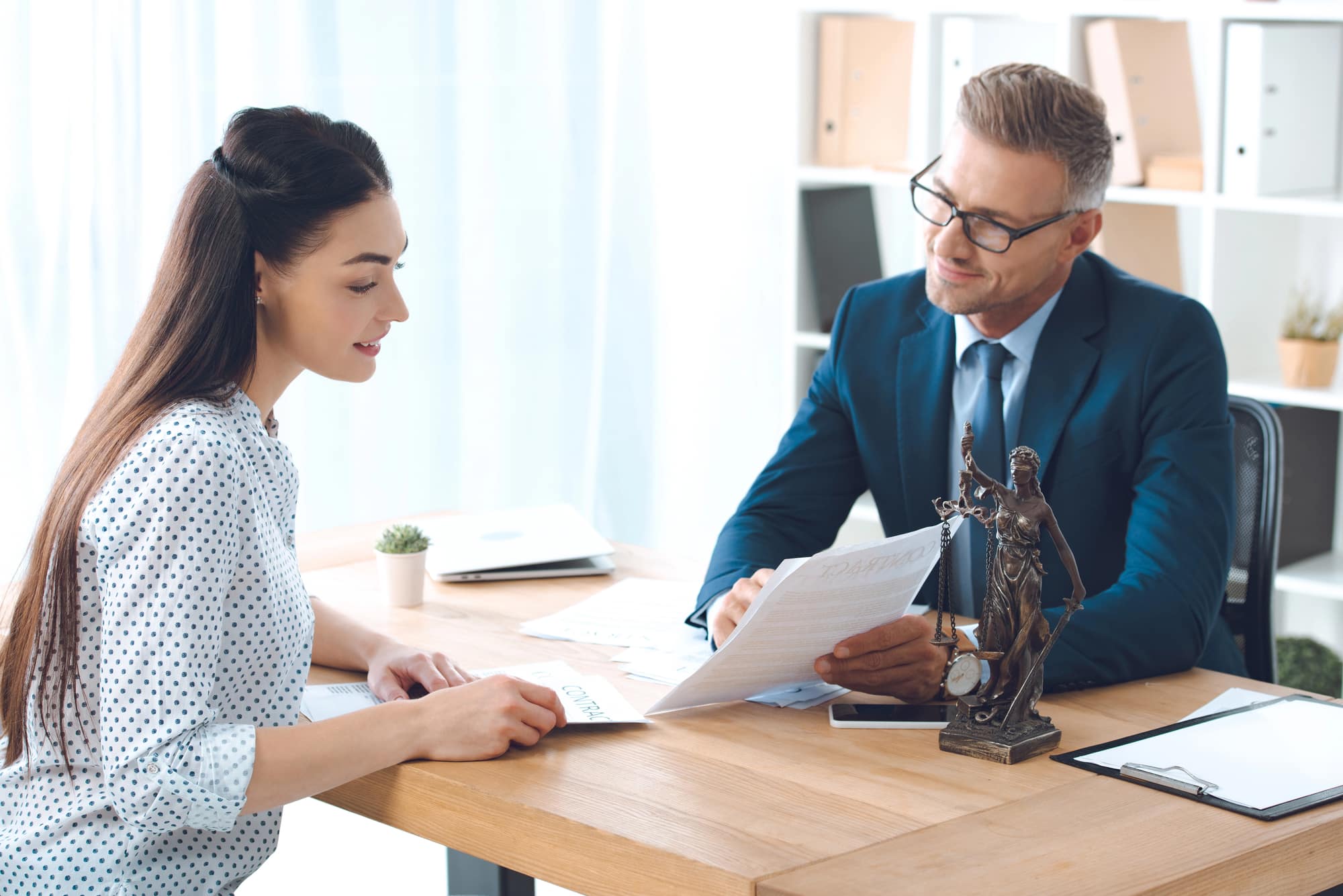 Lawyer reviewing case documents with a female client